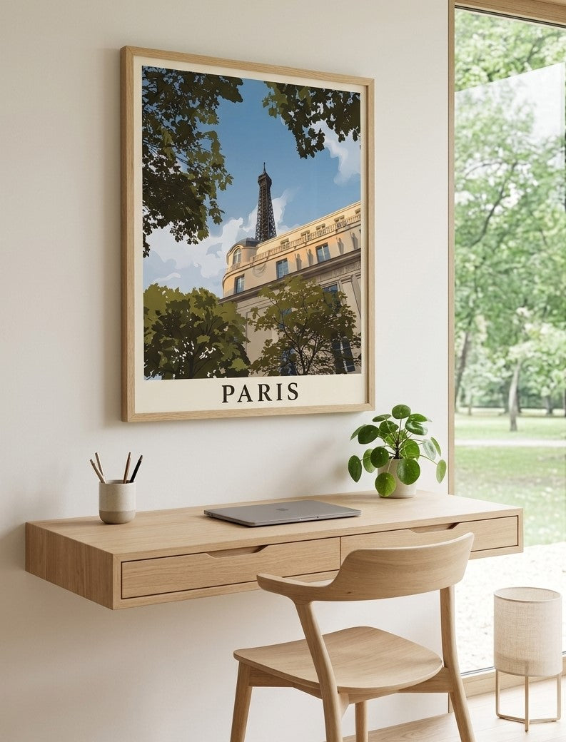 Framed Eiffel Tower Paris travel poster displayed above a wooden desk in a bright modern interior